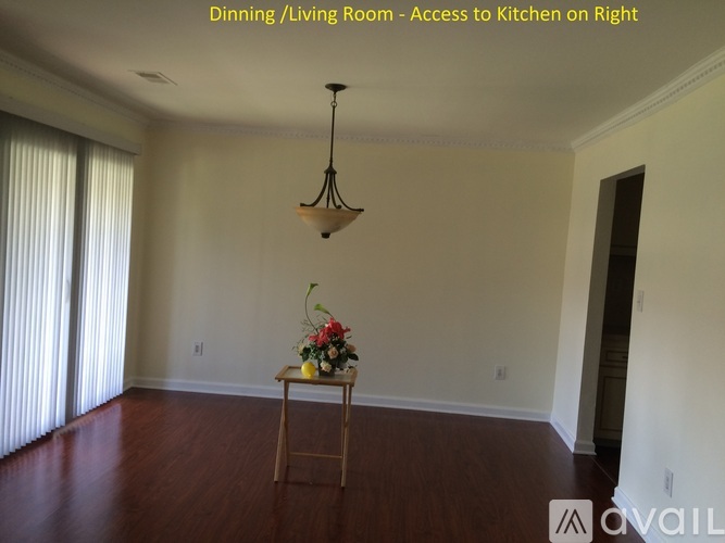 A dining room with a table and chairs set up.