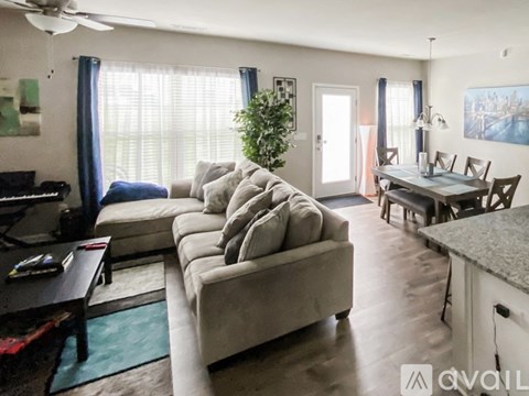 A living room with a grey couch and a coffee table.