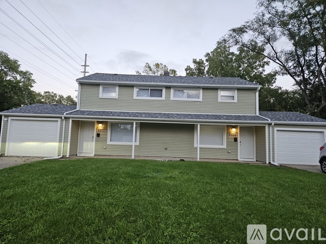 A two-story house with a garage is available for rent.