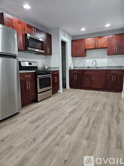 A kitchen with wooden cabinets and a refrigerator.