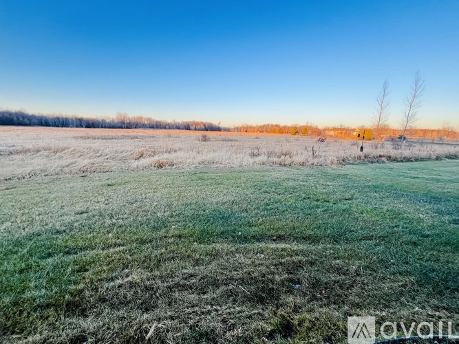 A frosty field with a person standing in the distance.