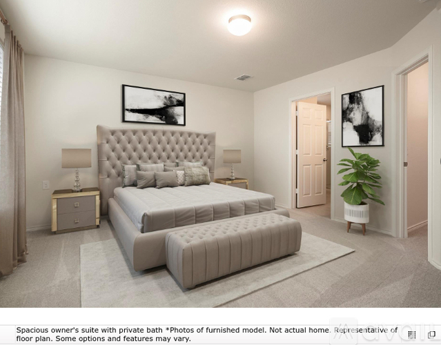 A spacious owner's suite with a private bath and a large bed.