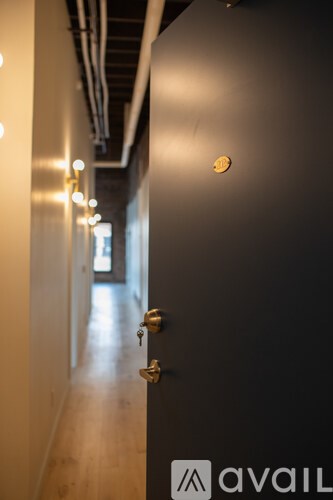 A black door with a key in the lock.