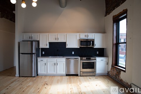 A kitchen with white cabinets and stainless steel appliances.