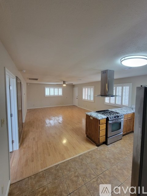 A kitchen with wooden cabinets and a stove top oven.