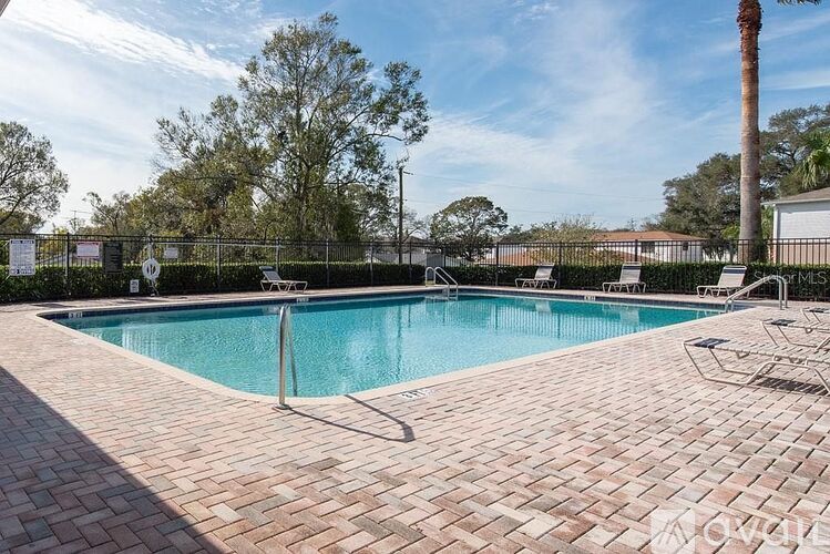 A rectangular pool with a brick border.