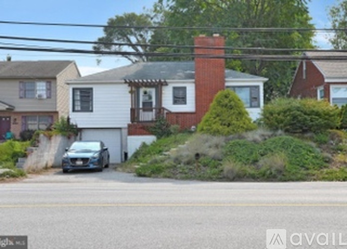 A house with a car parked in front of it.