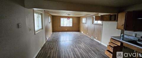 A kitchen area with wooden floors and a countertop.