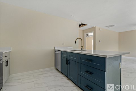 A kitchen with a sink and a counter.