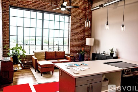 A modern kitchen with a large window and a dining area.