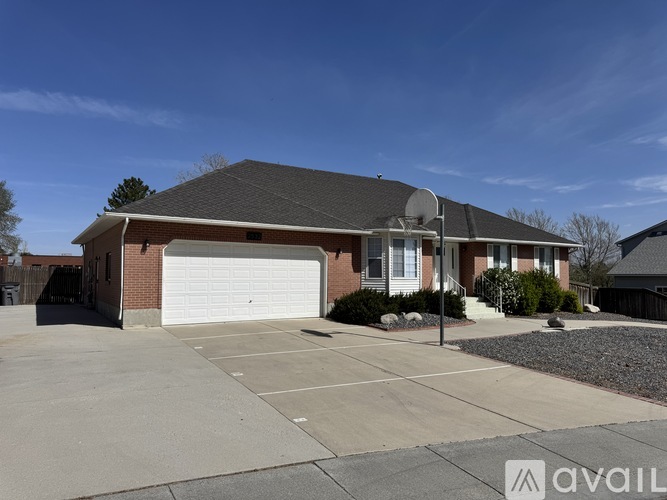 A house with a garage and driveway in front.