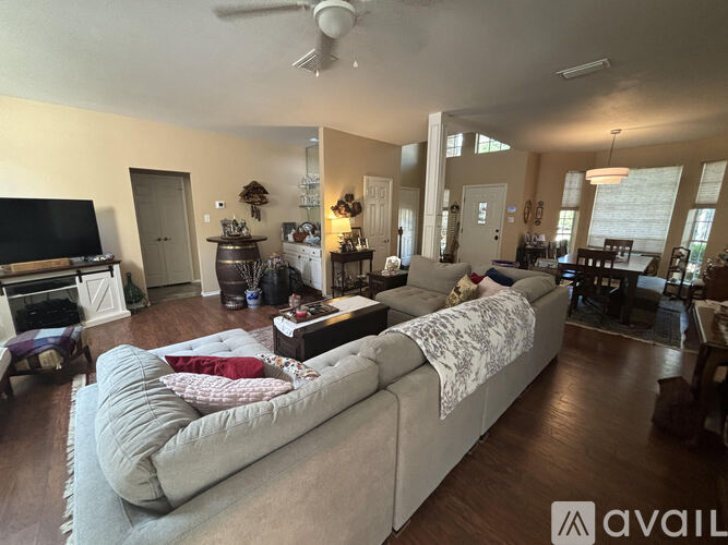 A living room with a large couch and a television.
