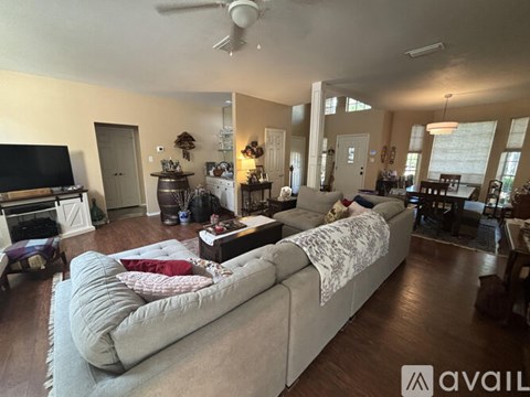 A living room with a large couch and a television.