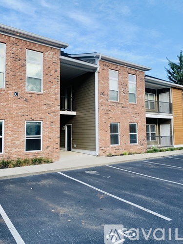 A building with a parking lot in front of it.
