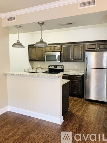 A kitchen with a white counter and wooden cabinets.