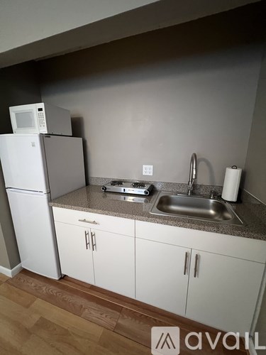 A kitchen with white cabinets and a granite countertop.