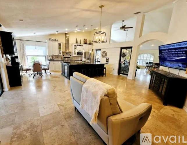A living room with a couch and a television.