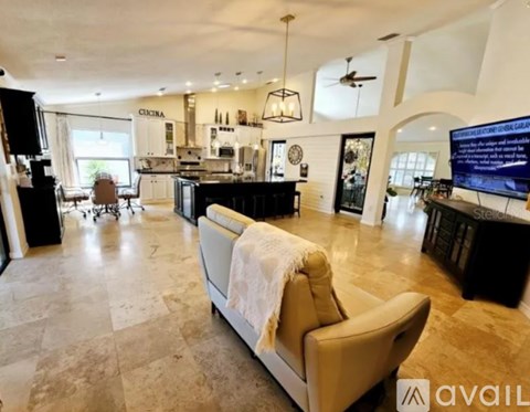 A living room with a couch and a television.