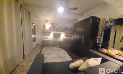 A living room with a couch and a television.