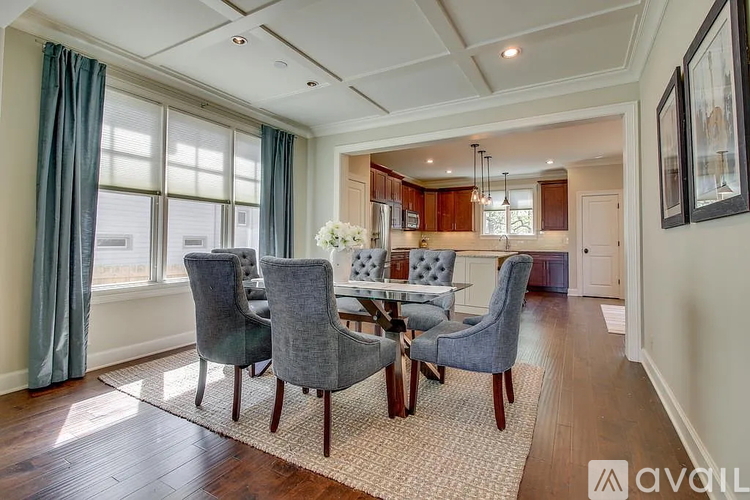 A dining room with a table set for four.