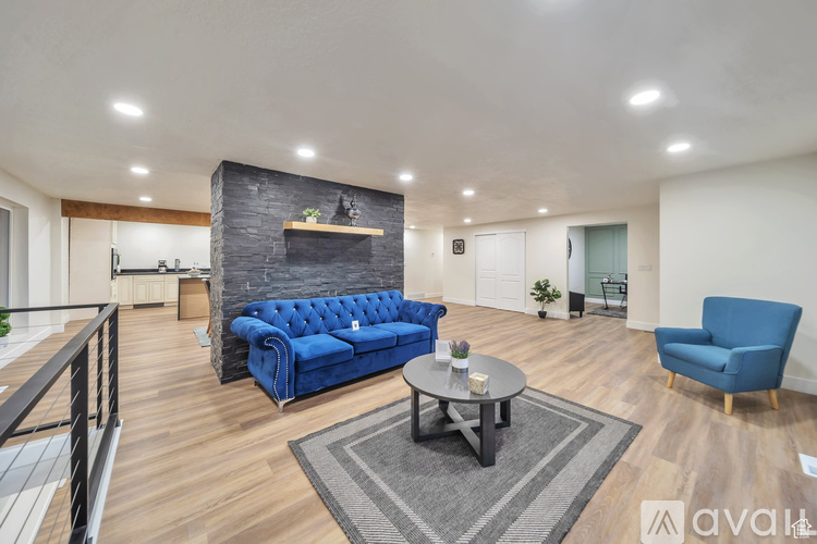 A living room with a blue sofa and a coffee table.