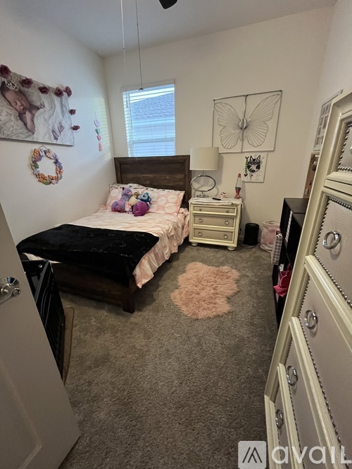 A bedroom with a bed, dresser, and mirror.