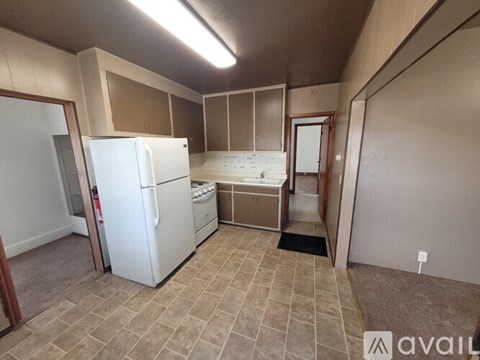 A kitchen with a white refrigerator and a white oven.