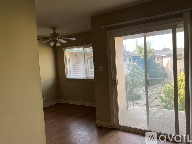 A room with a sliding glass door leading to a backyard.