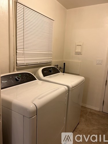 Two front load washing machines in a laundry room.