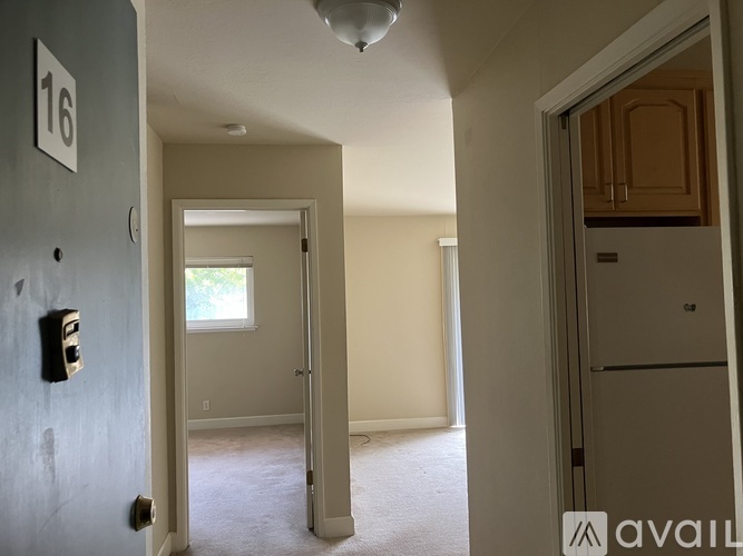 A room with a door numbered 16 and a window.
