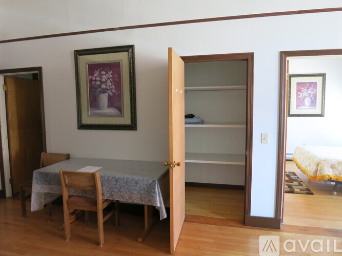 A dining room with a table and chairs.