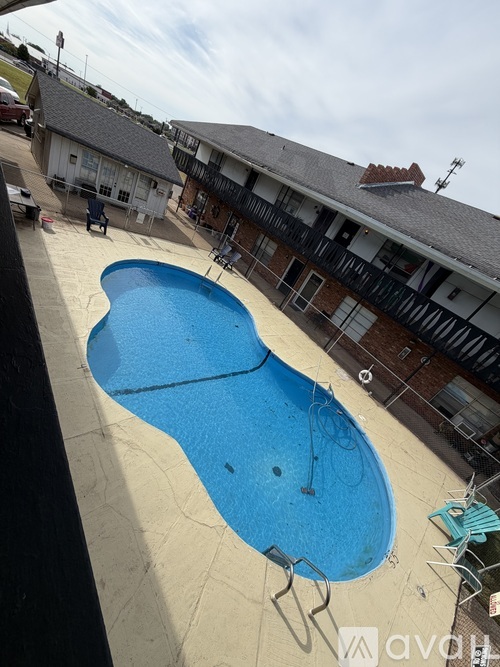 A blue swimming pool in a residential area.