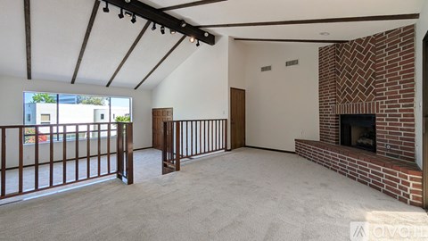 A living room with a fireplace and a balcony.
