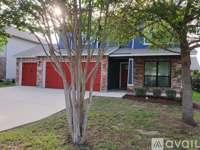A house with a red garage door is for sale.