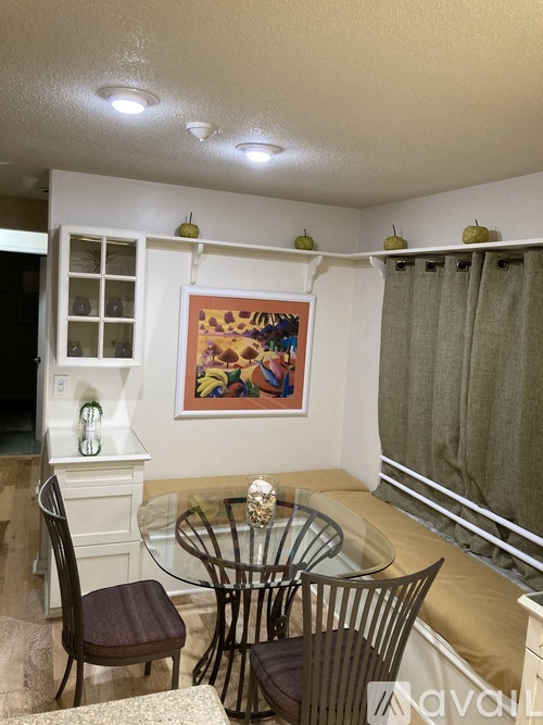 A dining room with a glass table and chairs.