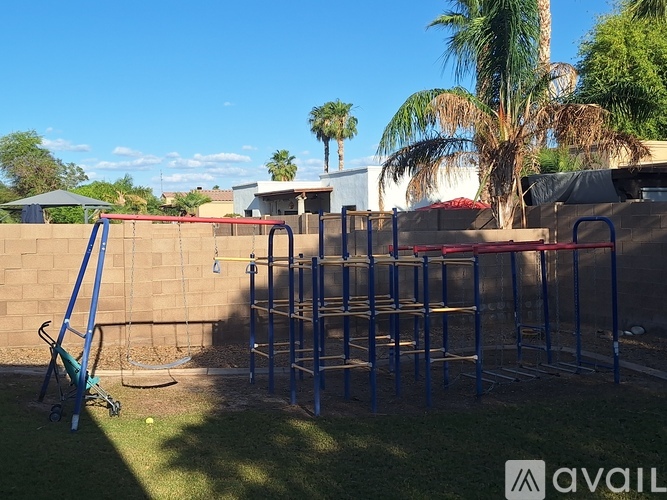 A playground with a swing set and a slide.