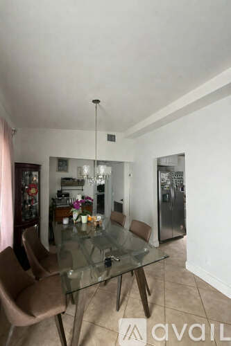 A glass dining table with chairs in a room.