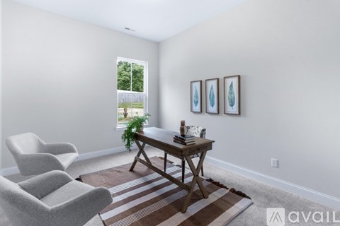A living room with a table, chairs and pictures on the wall.