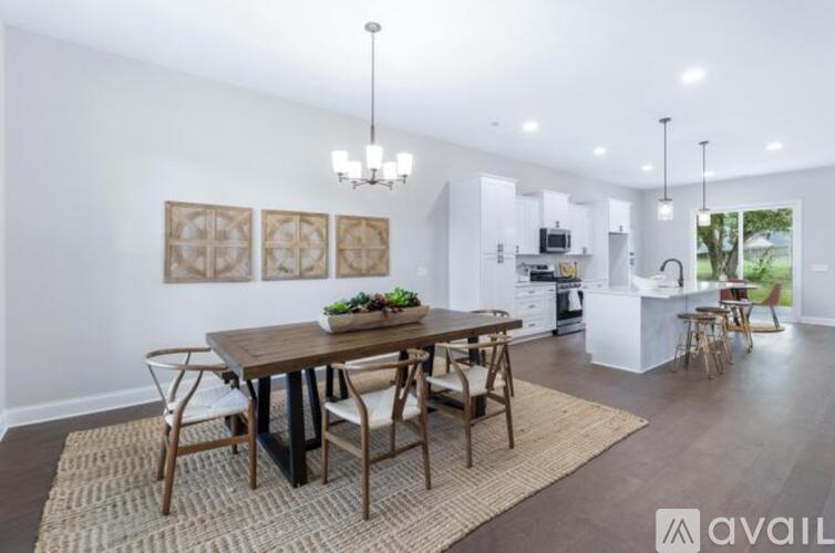 A modern dining room with a wooden table and chairs.