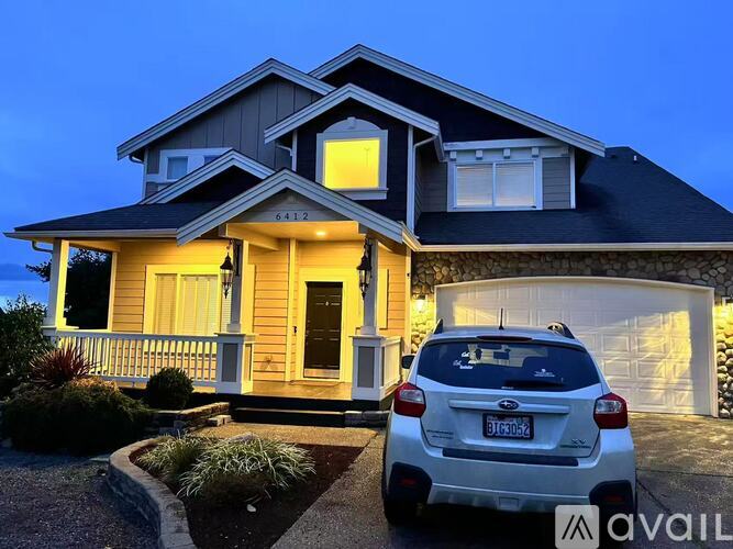 A house with a car parked in front of it.