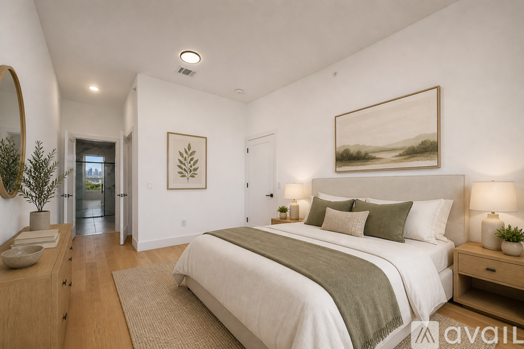 A bedroom with a large bed and a painting on the wall.