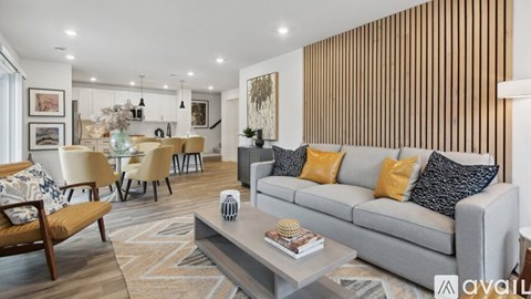 A living room with a grey couch and a coffee table in front of it.