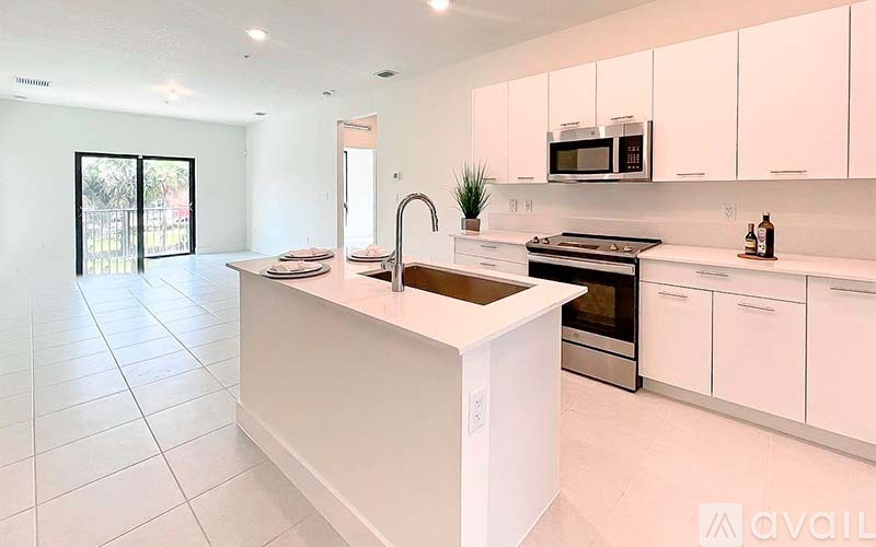 A modern kitchen with white cabinets and a central island.