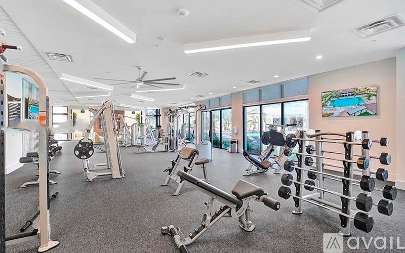 A well-equipped gym with various exercise machines and weights.