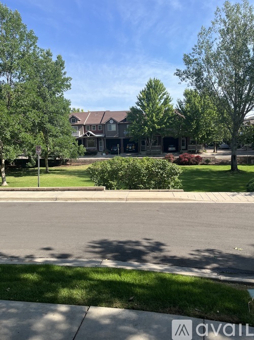 A house with a lawn and trees in front of it.