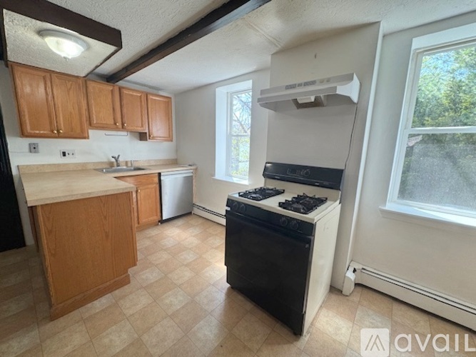 A kitchen with a black oven and a white stove top.