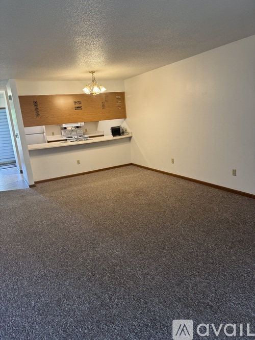 A room with a carpeted floor and a counter with a sign that says "FLOOR".