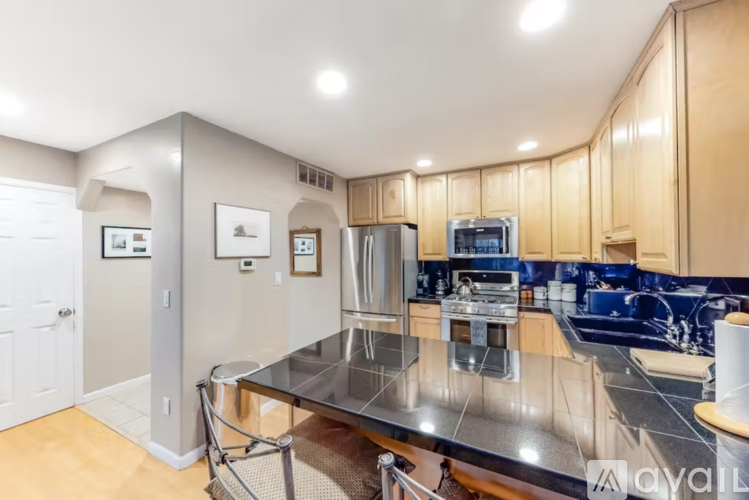 A kitchen with a table and chairs in the middle of it.