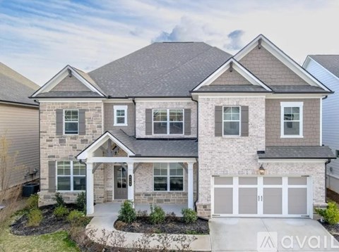 A house with a garage and a driveway in front.