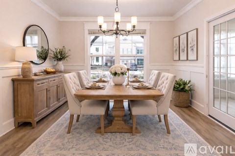 A dining room with a wooden table and chairs.
